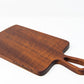 Extra small wood charcuterie board, made of a dark reddish-brown Sapele, with smooth curves and a unique teardrop handle.
