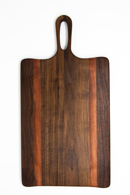 Medium size wood charcuterie board, made of a dark Walnut and two strips of dark reddish-brown Bubinga, with unique looped handle and exaggerated curves.