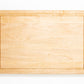 Extra large wood cutting board, made of light blonde Maple, with a juice groove and side handles.
