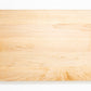 Extra large wood cutting board, made of light blonde Maple, with side handles.