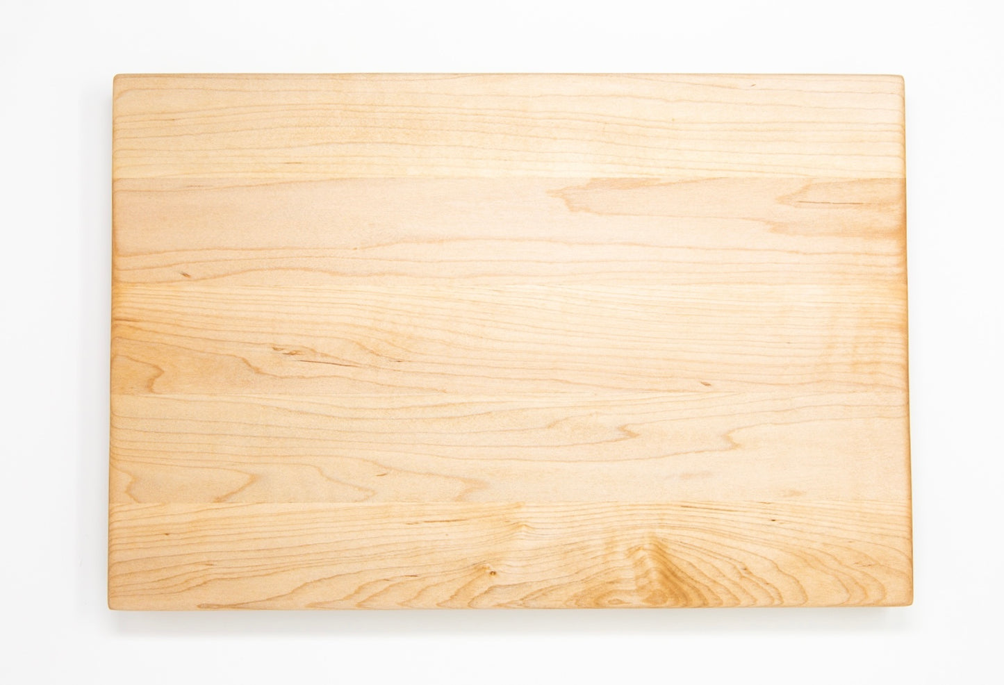 Medium size wood cutting board, made of light blonde Maple, with side handles.