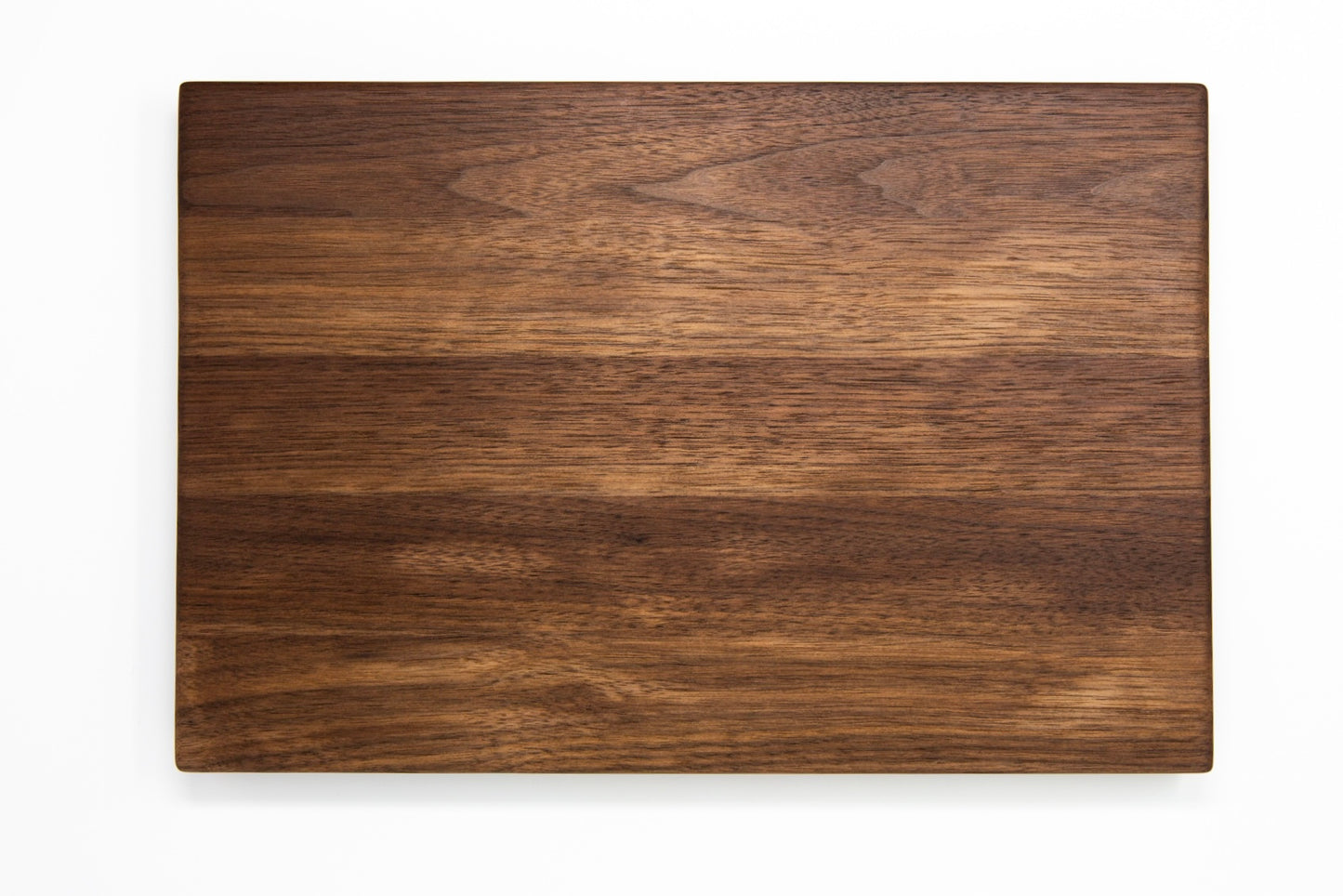 Medium size wood cutting board, made of dark walnut, with side handles.