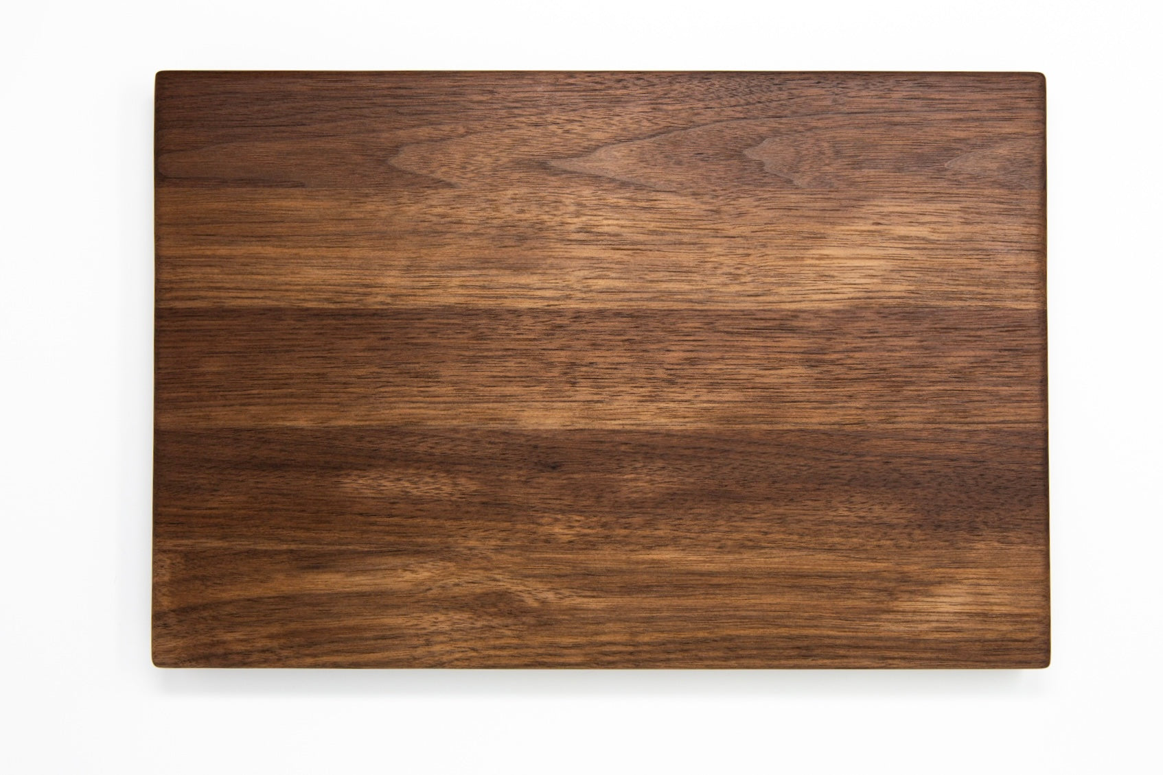 Medium size wood cutting board, made of dark walnut, with side handles.