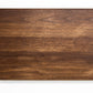 Extra large wood cutting board, made of dark Walnut, with side handles.